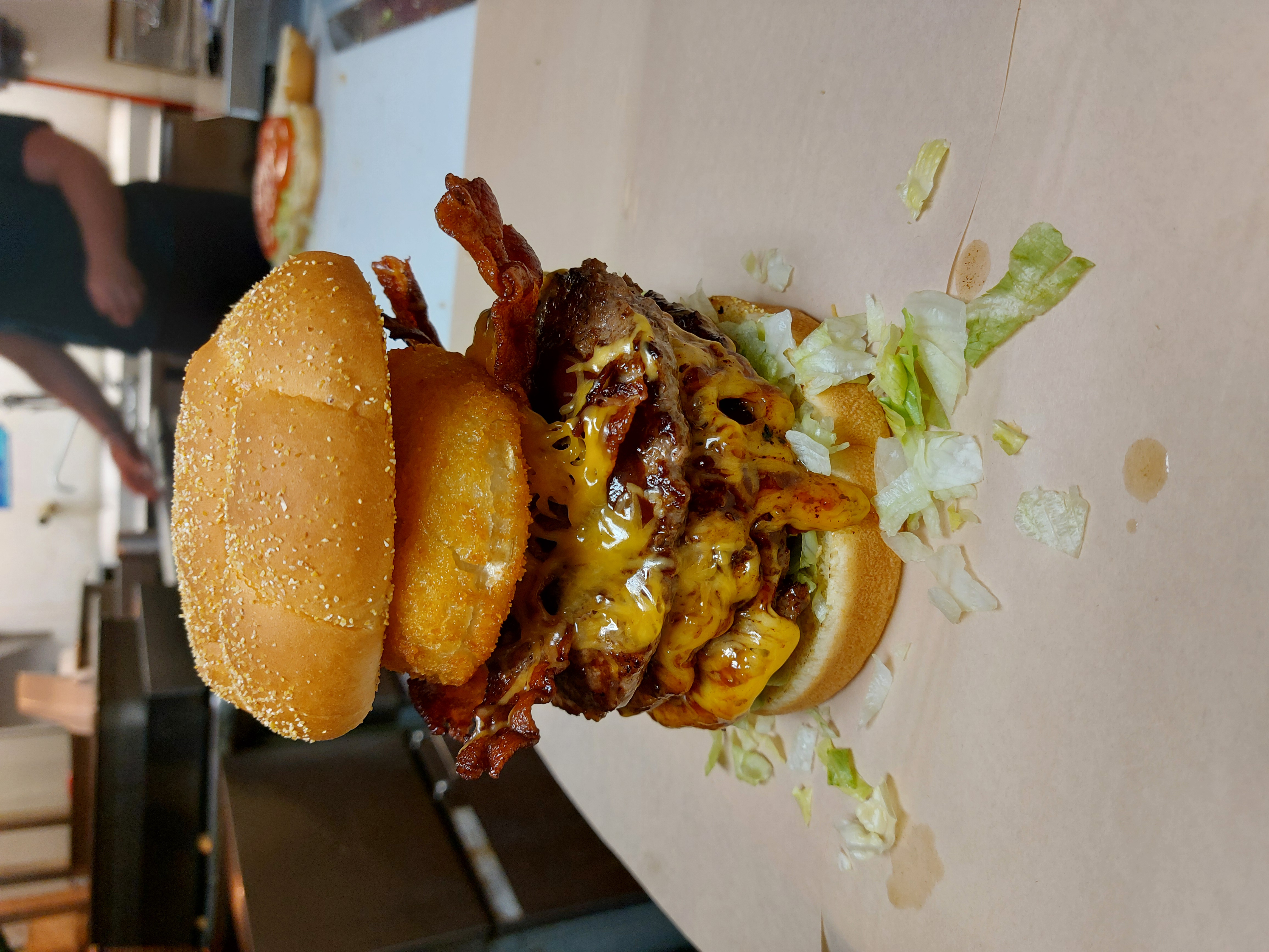 Stacked bacon cheeseburger with onion ring at Izzy's